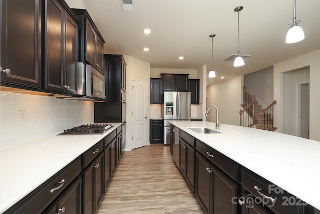 309 Kentmere Ln, Clover, SC 29710 - kitchen with a sink, appliances with stainless steel finishes, backsplash, and light wood finished floors