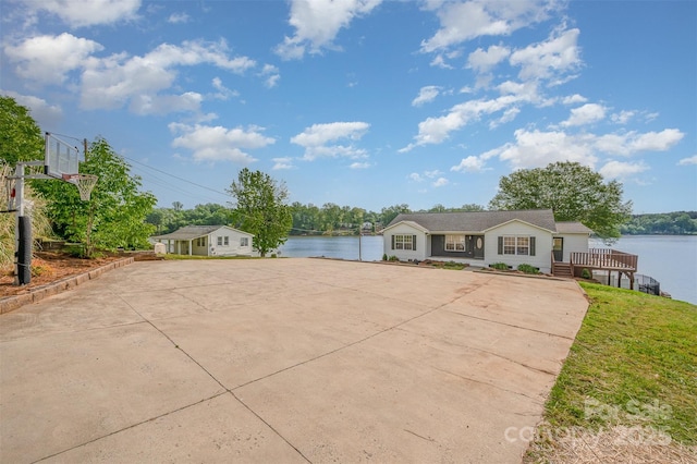 ranch-style house with a water view and a front lawn