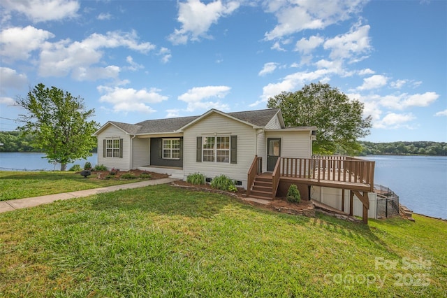 ranch-style house featuring a deck with water view and a front yard