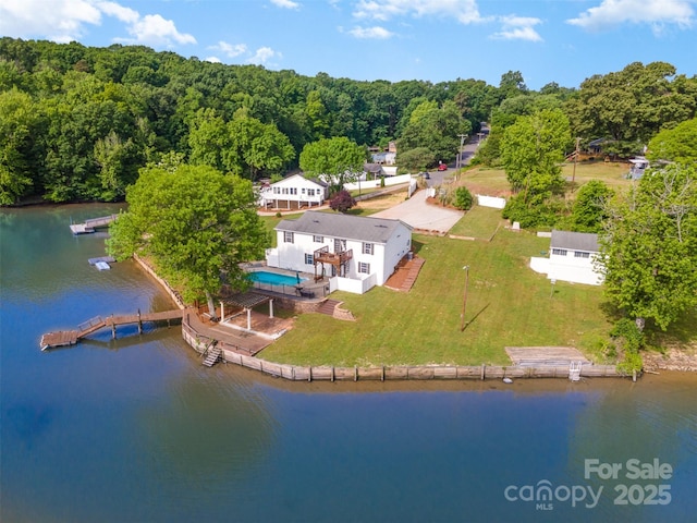 drone / aerial view featuring a water view and a view of trees