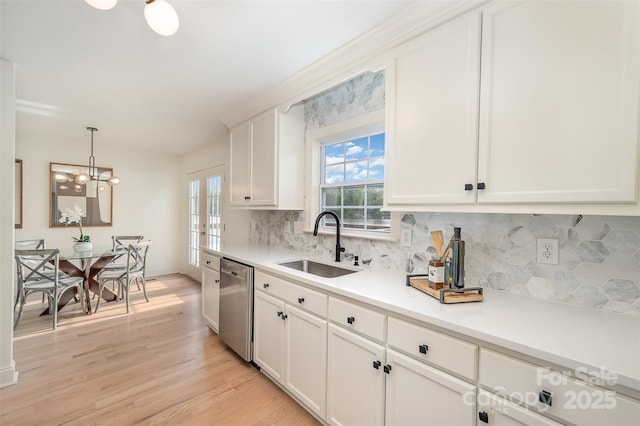 kitchen with a sink, white cabinetry, dishwasher, and tasteful backsplash