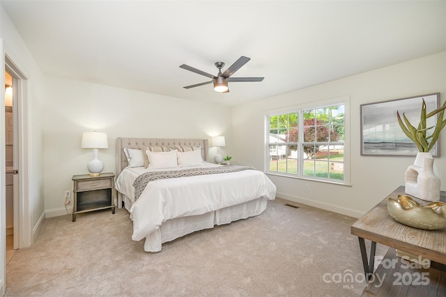 bedroom featuring baseboards, visible vents, and light carpet