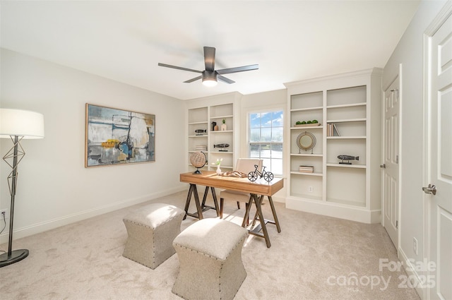 office space with ceiling fan, light carpet, and baseboards