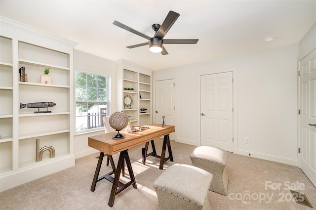 home office featuring baseboards, ceiling fan, and light colored carpet