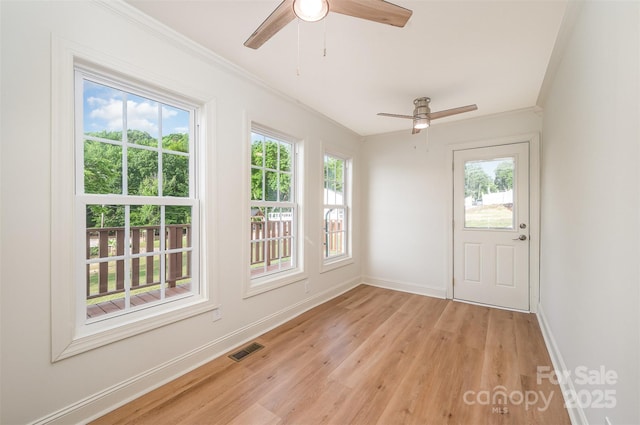 unfurnished sunroom with plenty of natural light and visible vents