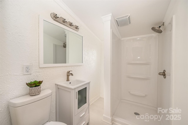 full bathroom with vanity, a stall shower, toilet, and visible vents