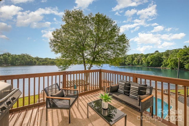 deck featuring a water view, outdoor lounge area, a forest view, and a grill