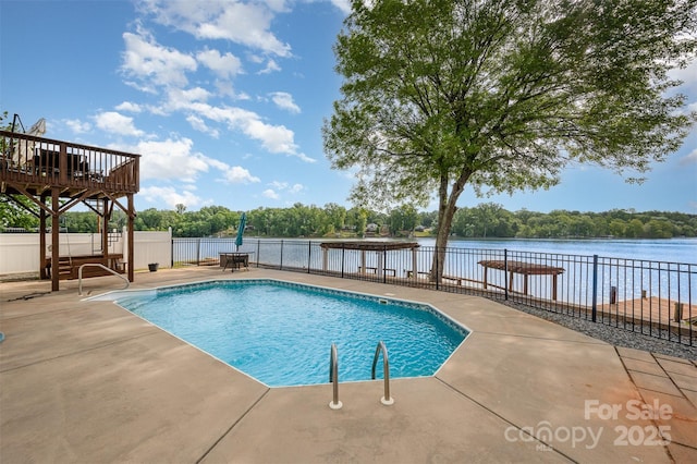 view of swimming pool with a water view, fence, a patio area, and a fenced in pool