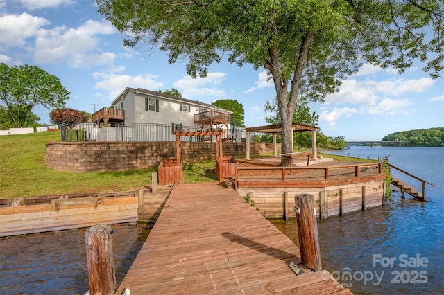 dock area with a water view, a gazebo, and a lawn