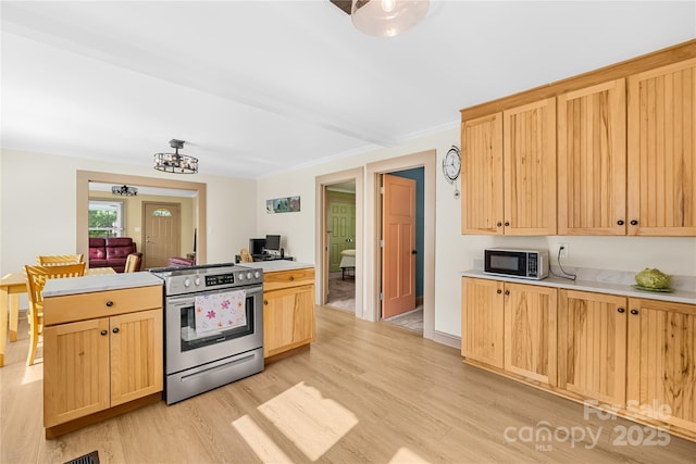 1104 Venus St, Kannapolis, NC 28083 - kitchen with electric range, light brown cabinets, light wood-style flooring, and light countertops