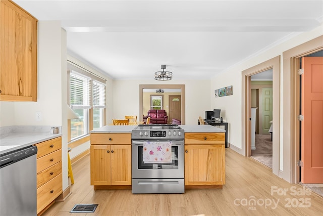 1104 Venus St, Kannapolis, NC 28083 - kitchen with stainless steel appliances, light wood-style floors, light brown cabinets, light countertops, and ornamental molding