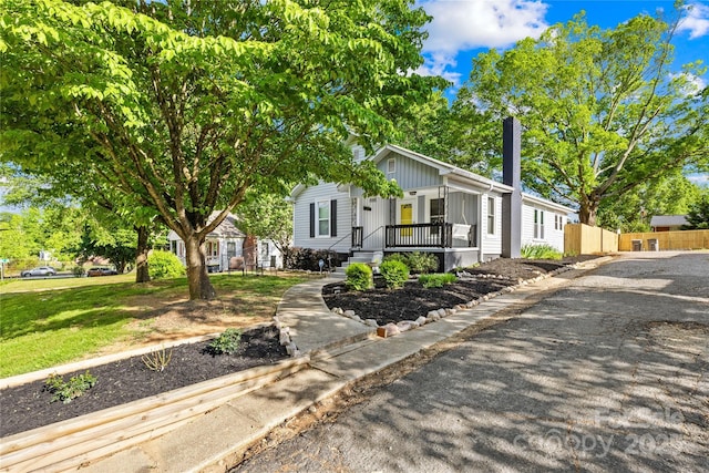 1104 Venus St, Kannapolis, NC 28083 - view of front of house with covered porch, fence, and board and batten siding