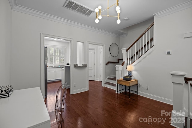 foyer entrance featuring ornamental molding, visible vents, stairs, a chandelier, and dark wood-type flooring