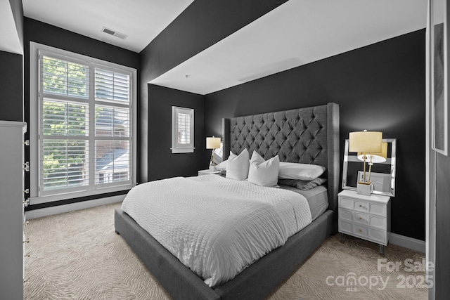 bedroom with baseboards, visible vents, and carpet floors