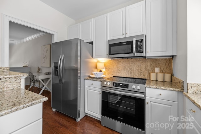 kitchen featuring stainless steel appliances, white cabinetry, decorative backsplash, and dark wood-type flooring