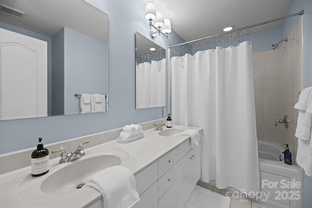 bathroom with a sink, tile patterned flooring, shower / bath combo with shower curtain, and visible vents