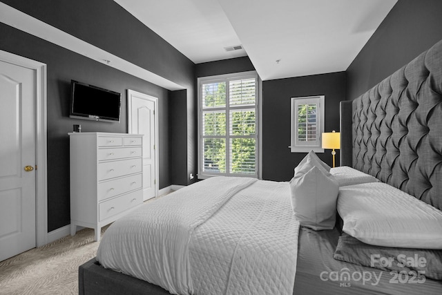 carpeted bedroom with baseboards and visible vents