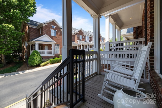 deck with a porch and a residential view
