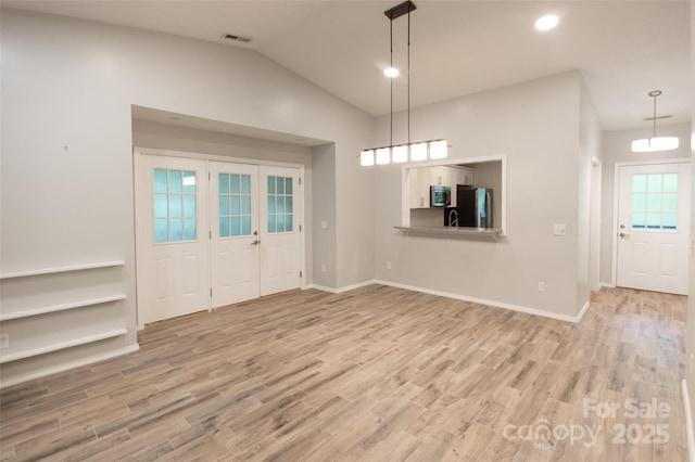 foyer featuring recessed lighting, baseboards, vaulted ceiling, and light wood-type flooring