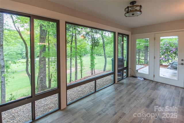 unfurnished sunroom featuring french doors and wood finished floors
