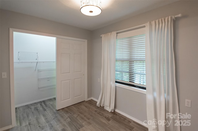 empty room featuring baseboards and wood finished floors
