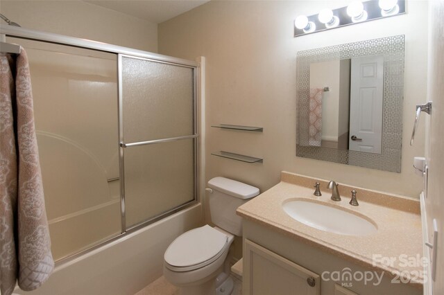 full bath featuring toilet, shower / bath combination with glass door, and vanity