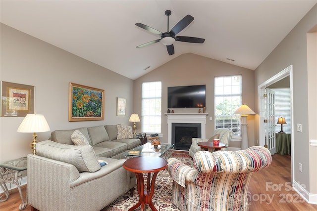 2114 N Castle Ct, Matthews, NC 28105 - living area with a ceiling fan, a fireplace, light wood-type flooring, visible vents, and lofted ceiling