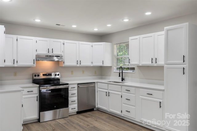 7525 Cedarbrook Dr, Charlotte, NC 28215 - kitchen with a sink, white cabinetry, appliances with stainless steel finishes, and under cabinet range hood