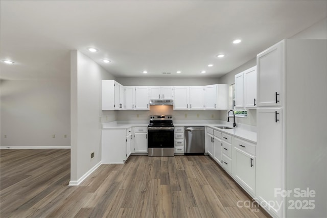 7525 Cedarbrook Dr, Charlotte, NC 28215 - kitchen with a sink, stainless steel appliances, wood finished floors, and under cabinet range hood