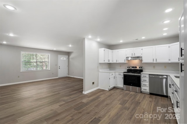7525 Cedarbrook Dr, Charlotte, NC 28215 - kitchen featuring under cabinet range hood, appliances with stainless steel finishes, dark wood-style floors, and light countertops