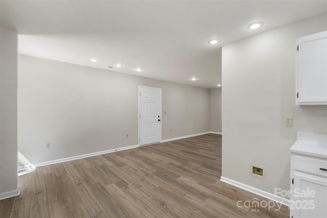 7525 Cedarbrook Dr, Charlotte, NC 28215 - below grade area with baseboards, recessed lighting, and wood finished floors