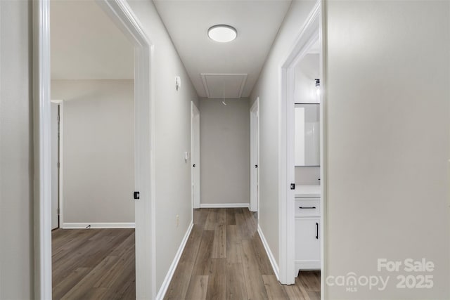 7525 Cedarbrook Dr, Charlotte, NC 28215 - hallway with baseboards, attic access, and wood finished floors