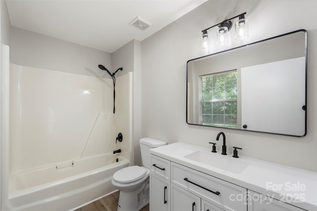 7525 Cedarbrook Dr, Charlotte, NC 28215 - full bathroom with visible vents, vanity, wood finished floors, toilet, and shower / bathing tub combination