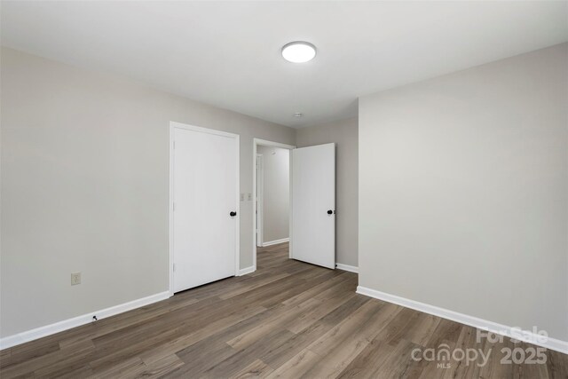 7525 Cedarbrook Dr, Charlotte, NC 28215 - empty room with baseboards and wood finished floors