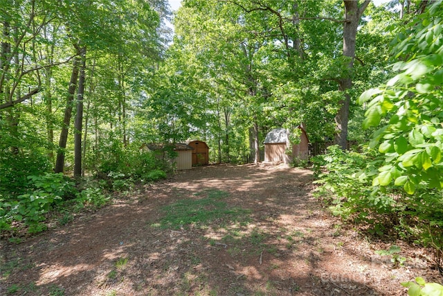 7525 Cedarbrook Dr, Charlotte, NC 28215 - view of yard featuring a storage unit and an outdoor structure
