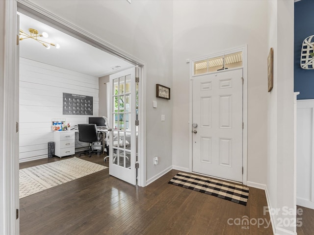 foyer featuring baseboards and dark wood finished floors