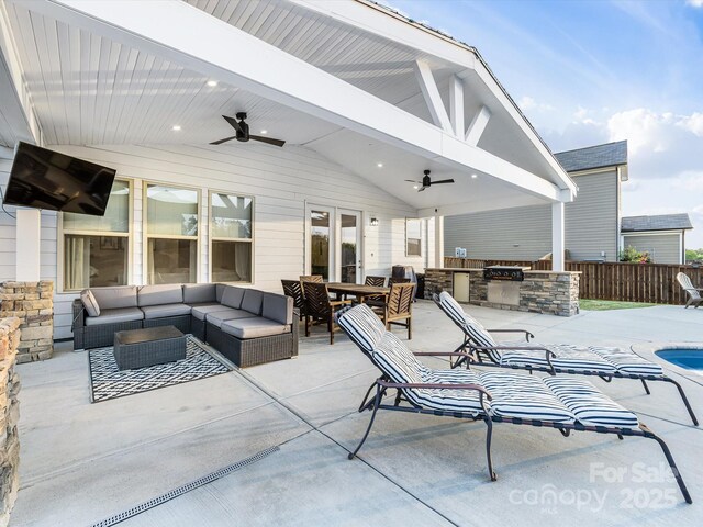 view of patio featuring area for grilling, fence, ceiling fan, and outdoor lounge area
