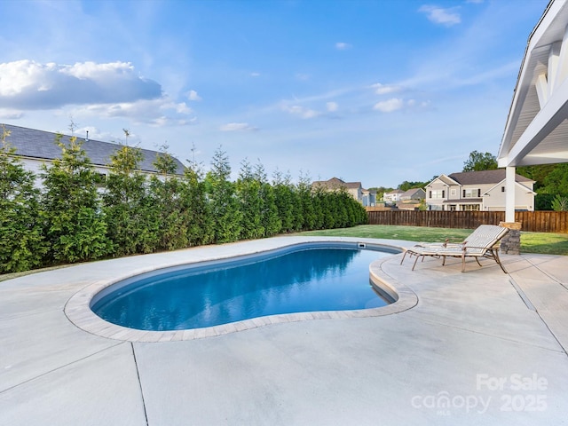 view of swimming pool with fence, a fenced in pool, a yard, and a patio area