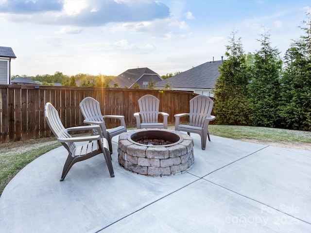 view of patio featuring an outdoor fire pit and fence