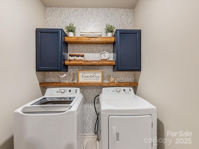 laundry area with independent washer and dryer and cabinet space