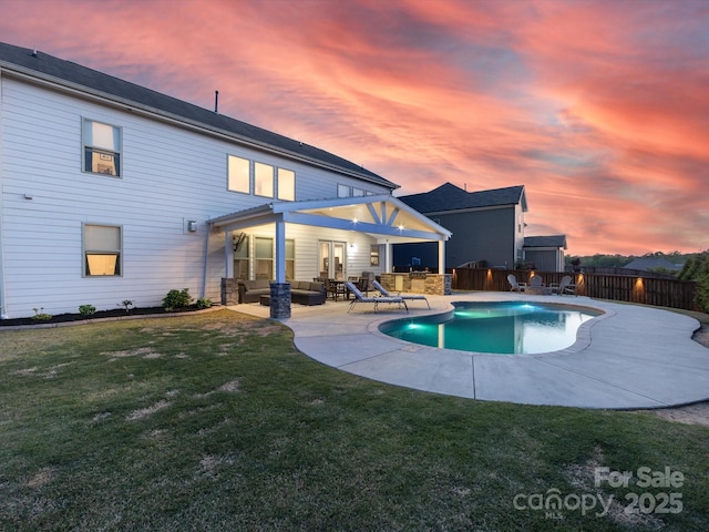 view of pool featuring fence, a fenced in pool, an outdoor living space, a patio area, and a yard