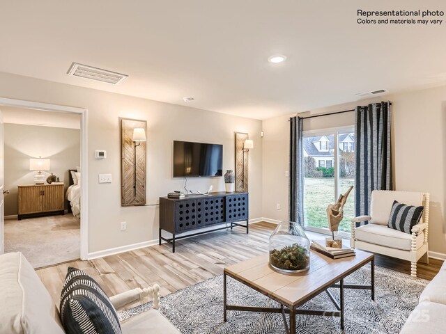 living area with visible vents, recessed lighting, light wood finished floors, and baseboards