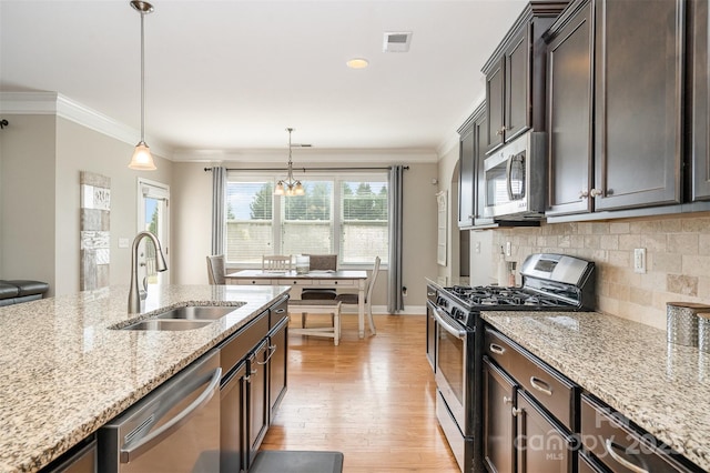 15807 Foreleigh Rd, Huntersville, NC 28078 - kitchen with stainless steel appliances, a sink, light wood-style floors, light stone countertops, and backsplash