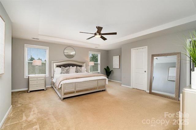15807 Foreleigh Rd, Huntersville, NC 28078 - carpeted bedroom with multiple windows, baseboards, a raised ceiling, and ceiling fan