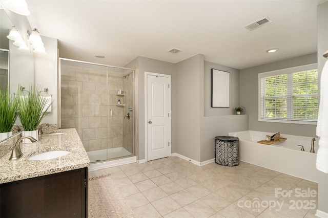 15807 Foreleigh Rd, Huntersville, NC 28078 - full bath with double vanity, a shower stall, a garden tub, tile patterned flooring, and baseboards