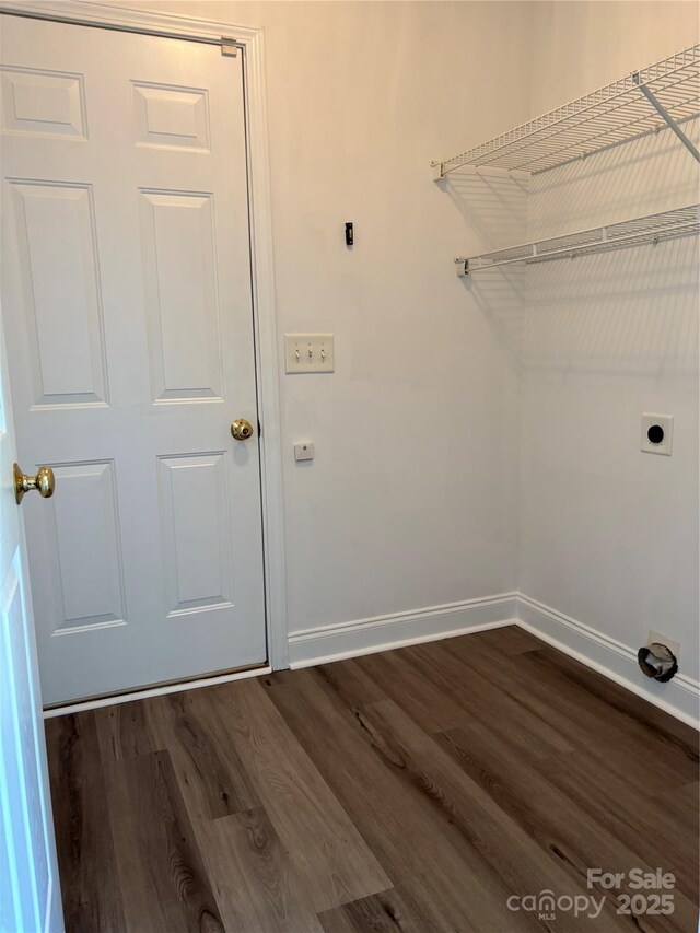 clothes washing area with laundry area, dark wood-style flooring, baseboards, and hookup for an electric dryer