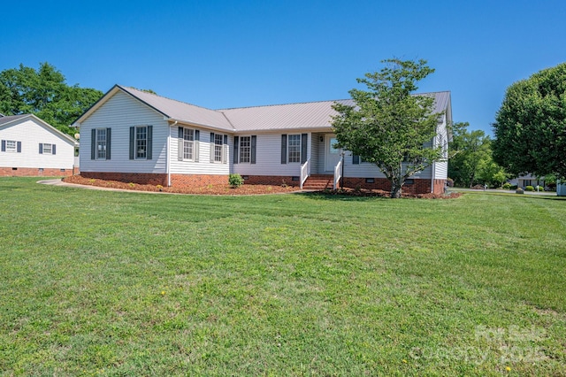 ranch-style house featuring a front lawn, metal roof, and crawl space