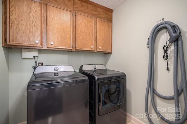 laundry room featuring cabinet space, independent washer and dryer, and baseboards
