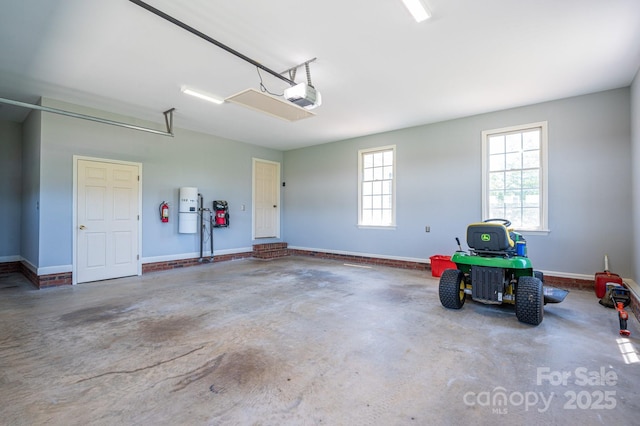 garage with baseboards and a garage door opener
