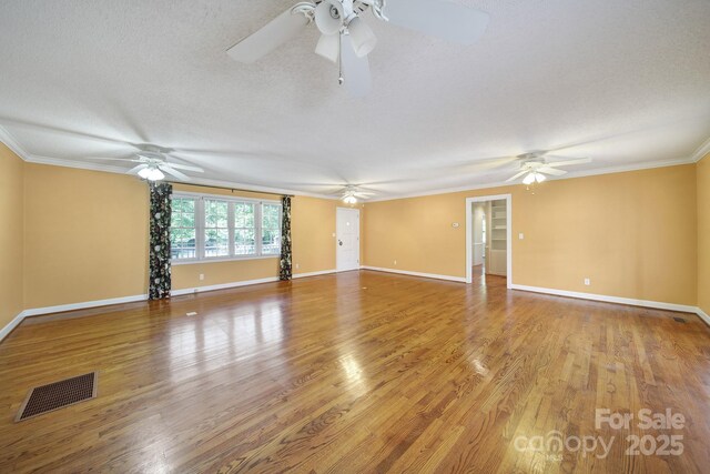 1723 Baskins Hill Rd, Heath Springs, SC 29058 - unfurnished room with ornamental molding, a ceiling fan, wood finished floors, and visible vents